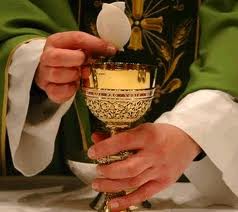 priest hands with Eucharist